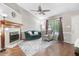 Living room with fireplace, hardwood floors, and comfy seating at 221 Southerby Dr, Garner, NC 27529