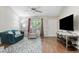 Living room with hardwood floors, comfortable seating, and large TV at 221 Southerby Dr, Garner, NC 27529