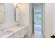 Bathroom with double vanity, quartz countertop, and white subway tile at 1817 N Lakeshore Dr, Chapel Hill, NC 27514