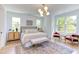 Bright bedroom featuring a comfortable bed and sitting area at 1817 N Lakeshore Dr, Chapel Hill, NC 27514