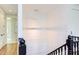Modern stairwell with white paneled walls and black railing at 1817 N Lakeshore Dr, Chapel Hill, NC 27514