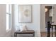 Bright hallway with bench, artwork, and view to staircase at 1817 N Lakeshore Dr, Chapel Hill, NC 27514
