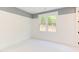 Spacious bedroom with window and gray accent wall at 1817 N Lakeshore Dr, Chapel Hill, NC 27514
