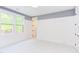 Spacious bedroom with window and gray accent wall at 1817 N Lakeshore Dr, Chapel Hill, NC 27514