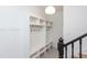 White built-in coat closet with shelves and hooks at 1817 N Lakeshore Dr, Chapel Hill, NC 27514