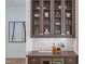 Close-up view of a built-in wet bar with glass-front cabinets at 1817 N Lakeshore Dr, Chapel Hill, NC 27514