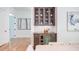 Built-in wet bar with wine cooler and glass-front cabinetry at 1817 N Lakeshore Dr, Chapel Hill, NC 27514