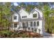 Modern farmhouse exterior with a metal roof and large windows at 1817 N Lakeshore Dr, Chapel Hill, NC 27514