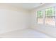 Bright bedroom with large window and white walls at 1817 N Lakeshore Dr, Chapel Hill, NC 27514