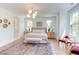Spacious main bedroom with plush bed and large windows at 1817 N Lakeshore Dr, Chapel Hill, NC 27514
