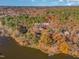 Lakefront property with home surrounded by colorful trees at 1817 N Lakeshore Dr, Chapel Hill, NC 27514