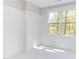 Spacious bedroom with window and white walls at 1817 N Lakeshore Dr, Chapel Hill, NC 27514