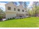 Back exterior view of the house, showcasing large windows and private backyard at 1817 N Lakeshore Dr, Chapel Hill, NC 27514