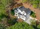 Stunning aerial view of a two-story home nestled in woods at 1817 N Lakeshore Dr, Chapel Hill, NC 27514