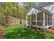 View of the home's exterior showcasing a screened porch and private backyard at 1817 N Lakeshore Dr, Chapel Hill, NC 27514