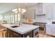 Open kitchen with island, stainless steel appliances, and breakfast bar at 1817 N Lakeshore Dr, Chapel Hill, NC 27514