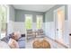 Spacious living area with a sofa, armchairs, and large windows at 1817 N Lakeshore Dr, Chapel Hill, NC 27514