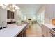 Open dining area with a large table, light colored wood floors and access to the back yard at 1817 N Lakeshore Dr, Chapel Hill, NC 27514