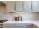 Kitchen detail showing white quartz countertop and gray cabinets at 1817 N Lakeshore Dr, Chapel Hill, NC 27514