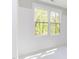 Bright bedroom with large window and white walls at 1817 N Lakeshore Dr, Chapel Hill, NC 27514