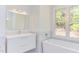 Bright bathroom with a floating vanity and bathtub at 1817 N Lakeshore Dr, Chapel Hill, NC 27514