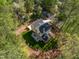 Aerial view showcasing the house, backyard, and surrounding wooded area at 1817 N Lakeshore Dr, Chapel Hill, NC 27514