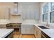 Sleek kitchen with gray cabinets, quartz countertops, and gas range at 1817 N Lakeshore Dr, Chapel Hill, NC 27514