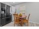 Eat-in kitchen with a small table and chairs, and stainless steel appliances at 221 Stroud St, Sanford, NC 27330
