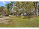 Large backyard with sheds and a wooden fence at 221 Stroud St, Sanford, NC 27330