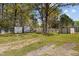 Spacious backyard with storage sheds and a partially fenced area at 221 Stroud St, Sanford, NC 27330