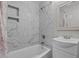 Clean bathroom with marble tile, a bathtub, and a vanity at 221 Stroud St, Sanford, NC 27330