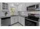 Modern kitchen with white cabinets, granite countertops, and stainless steel appliances at 221 Stroud St, Sanford, NC 27330