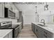 Modern kitchen with stainless steel appliances and gray cabinets at 210 Lilliput Ln, Wake Forest, NC 27587
