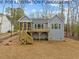 Gray house with a screened porch, deck and wooded backyard at 210 Lilliput Ln, Wake Forest, NC 27587