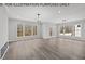 Open concept great room with hardwood floors and multiple windows at 210 Lilliput Ln, Wake Forest, NC 27587