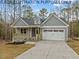 Exterior view of charming craftsman home with gray siding at 210 Lilliput Ln, Wake Forest, NC 27587