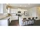 Modern kitchen with white cabinets, granite countertops, and stainless steel appliances at 401 Shorthorn Dr, Wake Forest, NC 27587