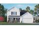 Two story home with white siding, a dark brown brick base, and a two car garage at 401 Shorthorn Dr, Wake Forest, NC 27587