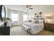 Large main bedroom with ceiling fan, ample natural light, and wall decor at 401 Shorthorn Dr, Wake Forest, NC 27587