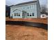 Rear view of a two-story light blue house with multiple windows and a spacious backyard at 219 Berry Mill Ln # 179, Raleigh, NC 27603