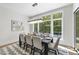 Bright dining room with large windows, hardwood floors, and a modern chandelier at 7644 Falls Creek Ln, Raleigh, NC 27614