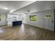 Open living room and kitchen with light walls and wood-look floors at 825 Chalmers St, Durham, NC 27707