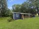 Charming one-story home with blue siding and a wood porch at 825 Chalmers St, Durham, NC 27707