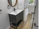Modern bathroom with floating vanity and round mirror at 825 Chalmers St, Durham, NC 27707