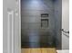 Modern shower with dark slate tile and built-in shelves at 825 Chalmers St, Durham, NC 27707