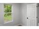 Bright bedroom with wood-look floors and window at 825 Chalmers St, Durham, NC 27707