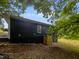 Dark-colored siding home with a wooded backyard at 825 Chalmers St, Durham, NC 27707