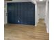 Living room with hardwood floors and a navy blue accent wall at 825 Chalmers St, Durham, NC 27707
