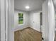Bright bedroom with wood-look floors and a large window at 825 Chalmers St, Durham, NC 27707