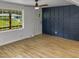 Bright living room with wood flooring and a navy blue accent wall at 825 Chalmers St, Durham, NC 27707